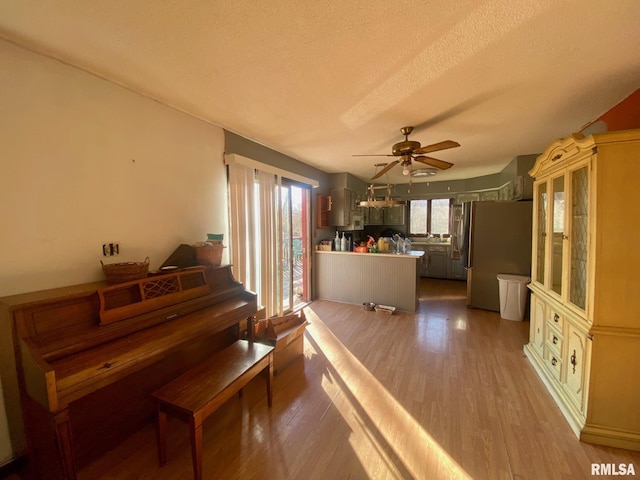 miscellaneous room with ceiling fan, hardwood / wood-style floors, and a textured ceiling