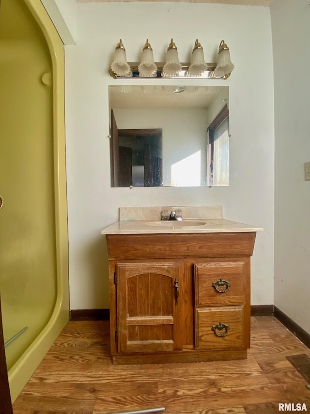 bathroom with vanity and wood-type flooring