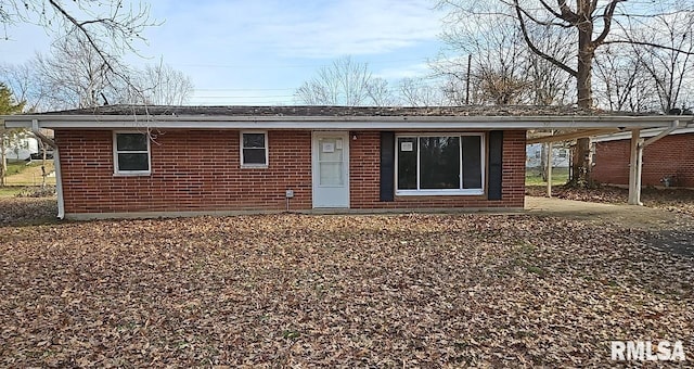 back of property with a carport