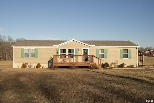 view of front of property with a front yard and a deck