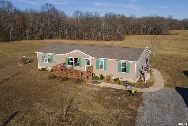 manufactured / mobile home with a front yard and a deck