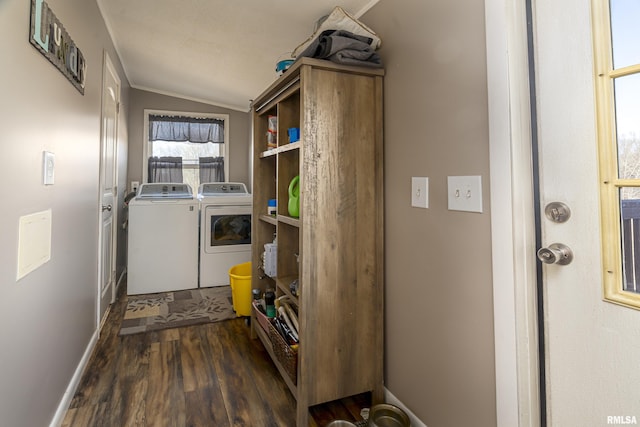 clothes washing area featuring dark hardwood / wood-style flooring and washer and dryer