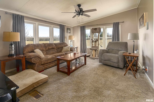 carpeted living room with ornamental molding, lofted ceiling, and ceiling fan