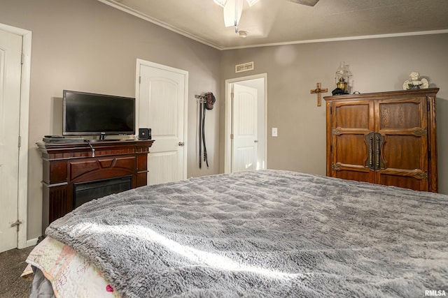 bedroom with ornamental molding and ceiling fan