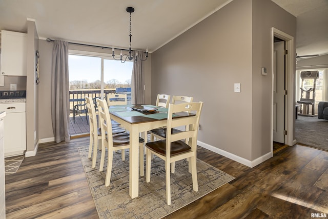 dining area with vaulted ceiling, ornamental molding, dark wood-type flooring, and a chandelier