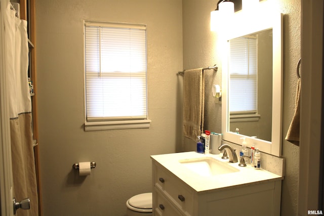 bathroom featuring vanity and toilet