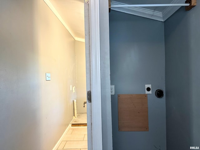 interior space with baseboards, ornamental molding, and electric dryer hookup