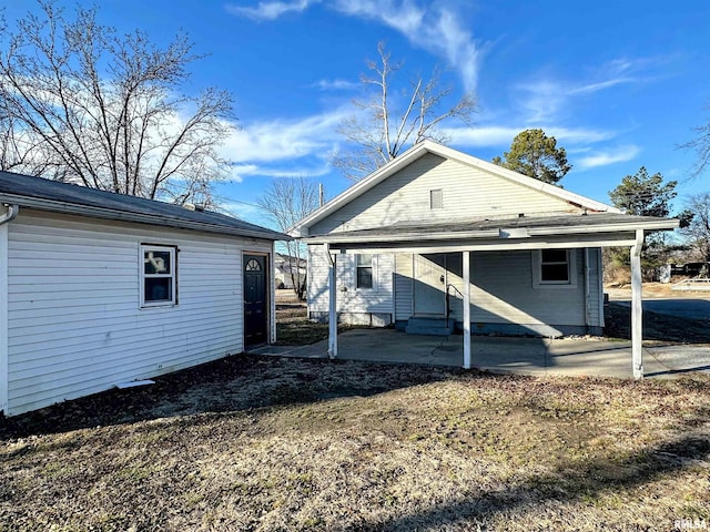 back of property featuring entry steps and a patio area