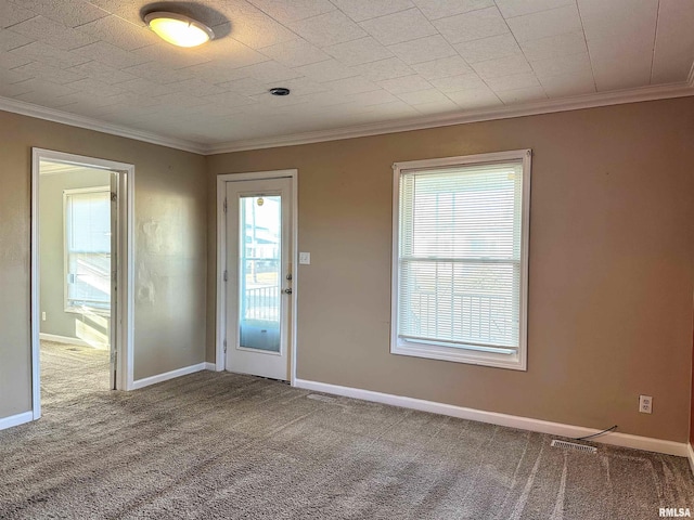 interior space with carpet floors, visible vents, crown molding, and baseboards