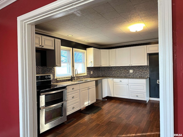 kitchen featuring white cabinetry, range with two ovens, and a sink