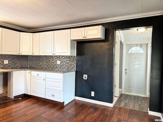 kitchen featuring ornamental molding, decorative backsplash, dark wood finished floors, and white cabinets