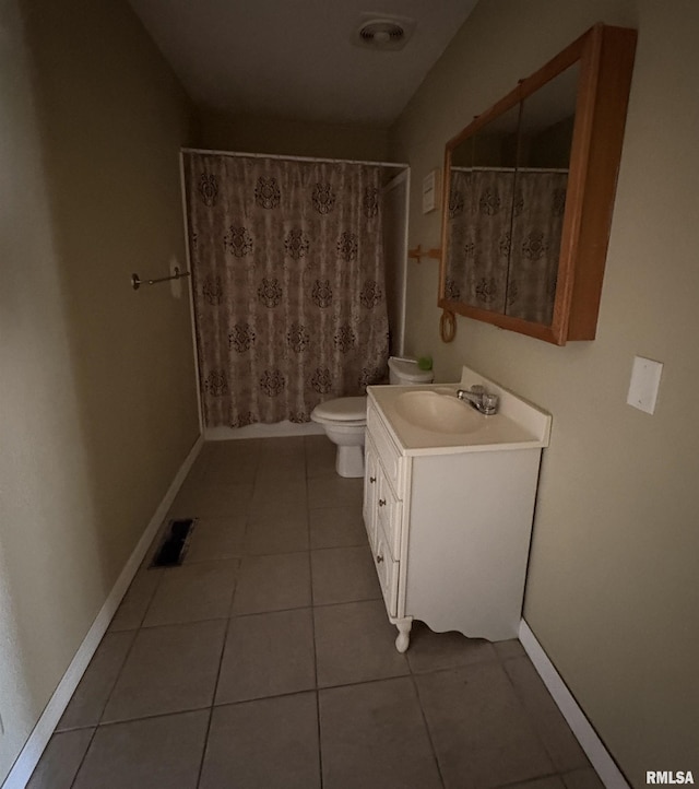 bathroom featuring tile patterned floors, toilet, and vanity