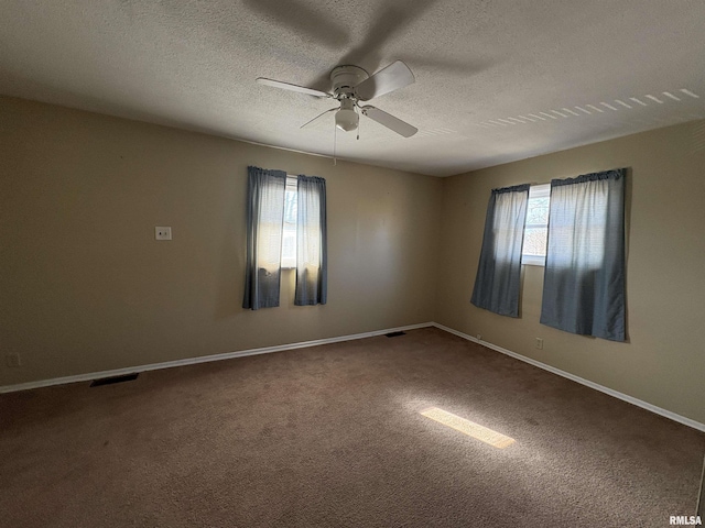 carpeted spare room with ceiling fan and a textured ceiling