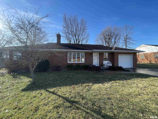 back of property with a lawn and a patio