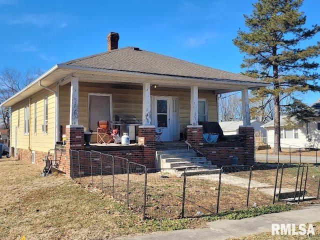 rear view of house featuring covered porch