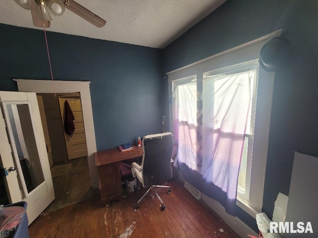 office space featuring ceiling fan, a textured ceiling, and dark hardwood / wood-style flooring