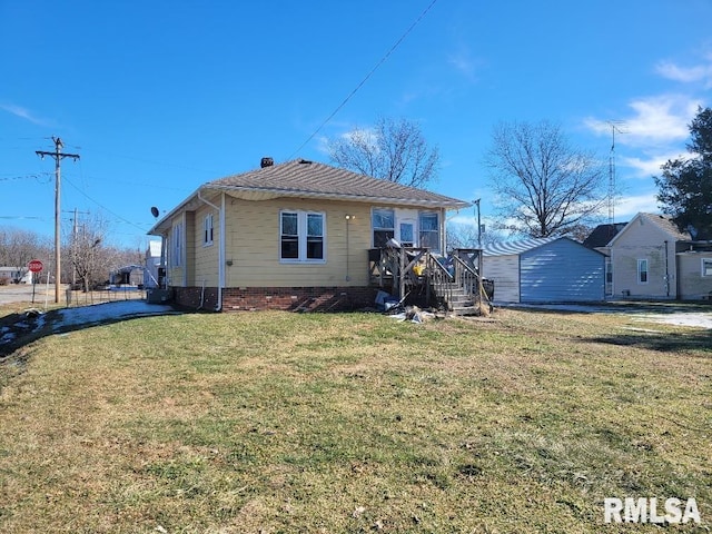 rear view of property featuring a yard