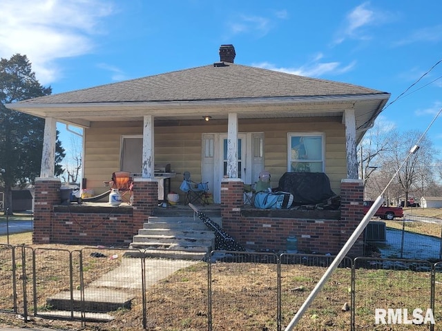 rear view of house featuring a porch