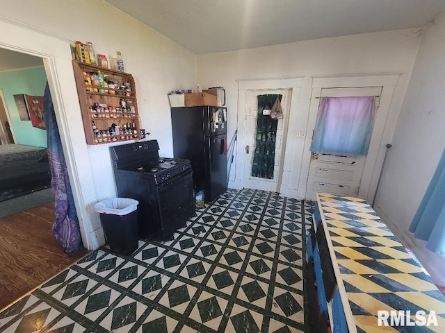 bedroom featuring black refrigerator