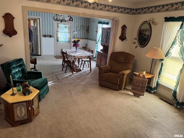 living room featuring ornamental molding, carpet, and a wealth of natural light