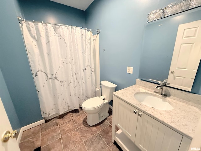 bathroom featuring tile patterned flooring, vanity, and toilet