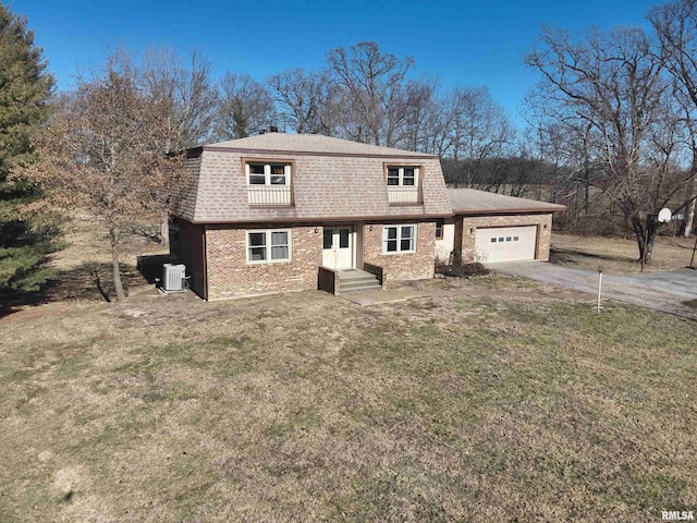 view of front property with a garage, a front lawn, and central air condition unit