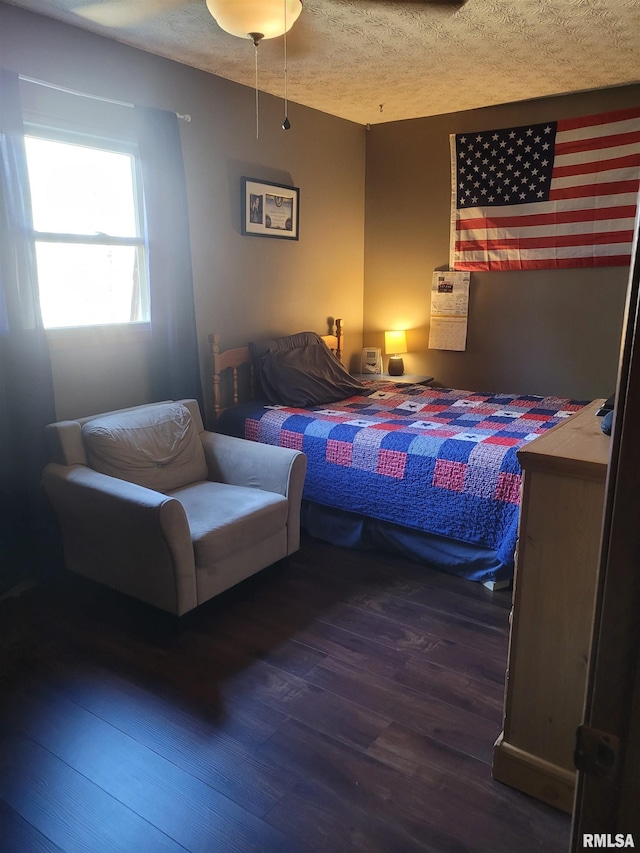 bedroom featuring dark wood-type flooring and a textured ceiling