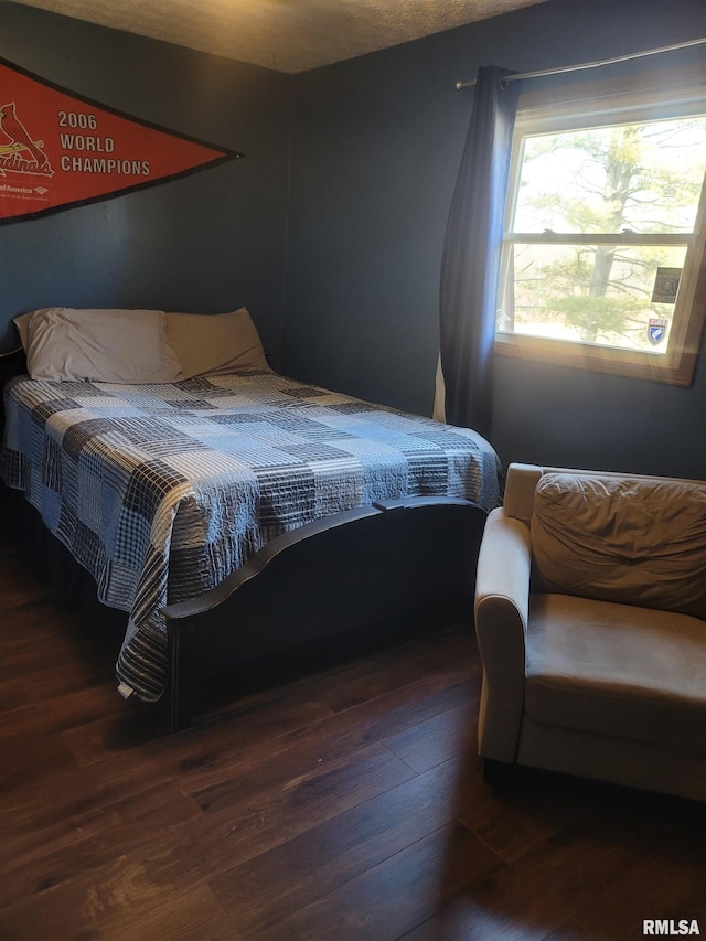 bedroom featuring dark hardwood / wood-style flooring