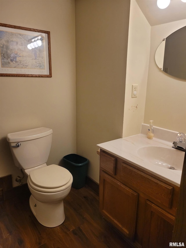 bathroom with vanity, hardwood / wood-style flooring, and toilet