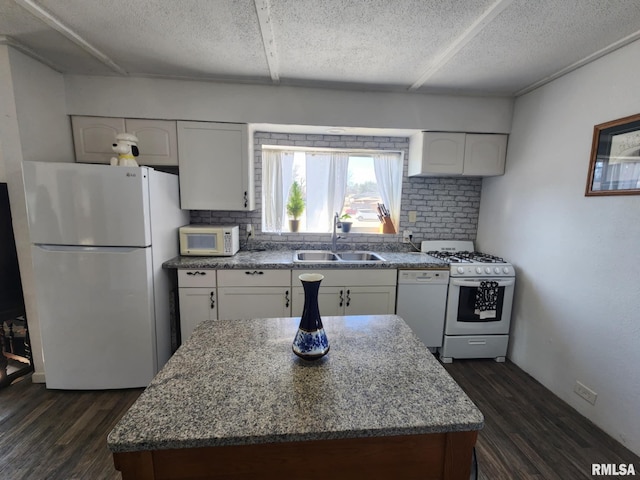 kitchen featuring white appliances, dark hardwood / wood-style floors, sink, and white cabinets