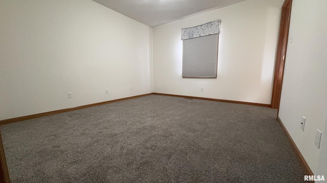 empty room featuring dark colored carpet