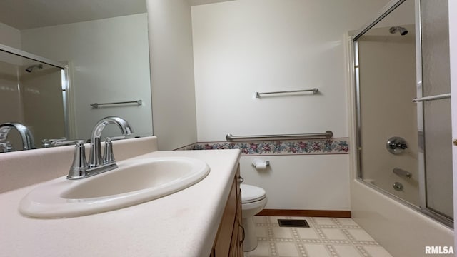 full bathroom featuring vanity, combined bath / shower with glass door, and toilet