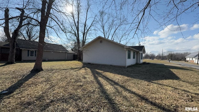 view of side of home with a lawn