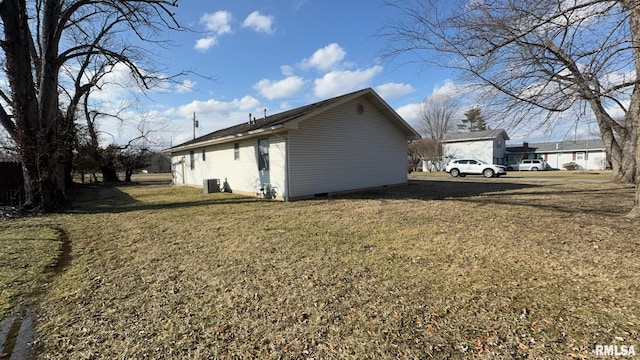 view of side of home with a lawn and central air condition unit