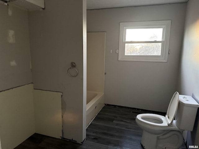 bathroom with wood-type flooring, shower with separate bathtub, and toilet