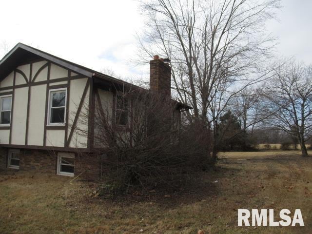 view of property exterior with a yard