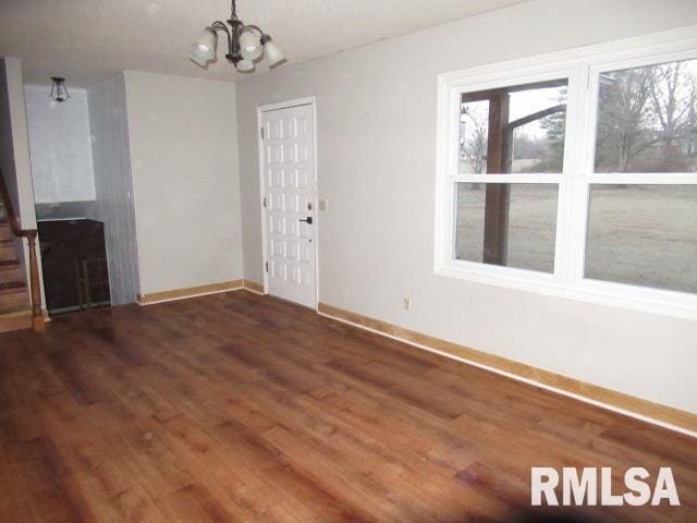 interior space with dark hardwood / wood-style flooring and a notable chandelier