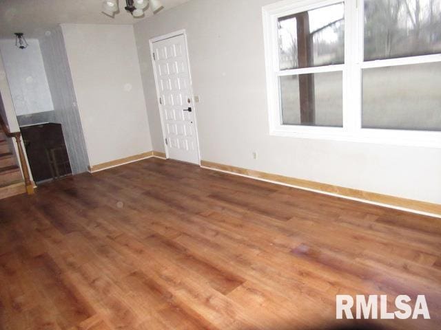 unfurnished living room with dark hardwood / wood-style floors