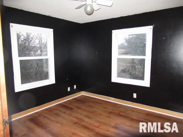 empty room with wood-type flooring and ceiling fan