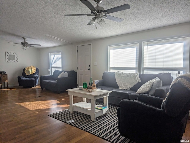 living room with ceiling fan, dark hardwood / wood-style floors, and a textured ceiling