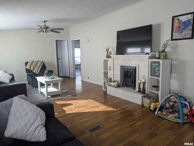 living room with ceiling fan, hardwood / wood-style floors, and a textured ceiling