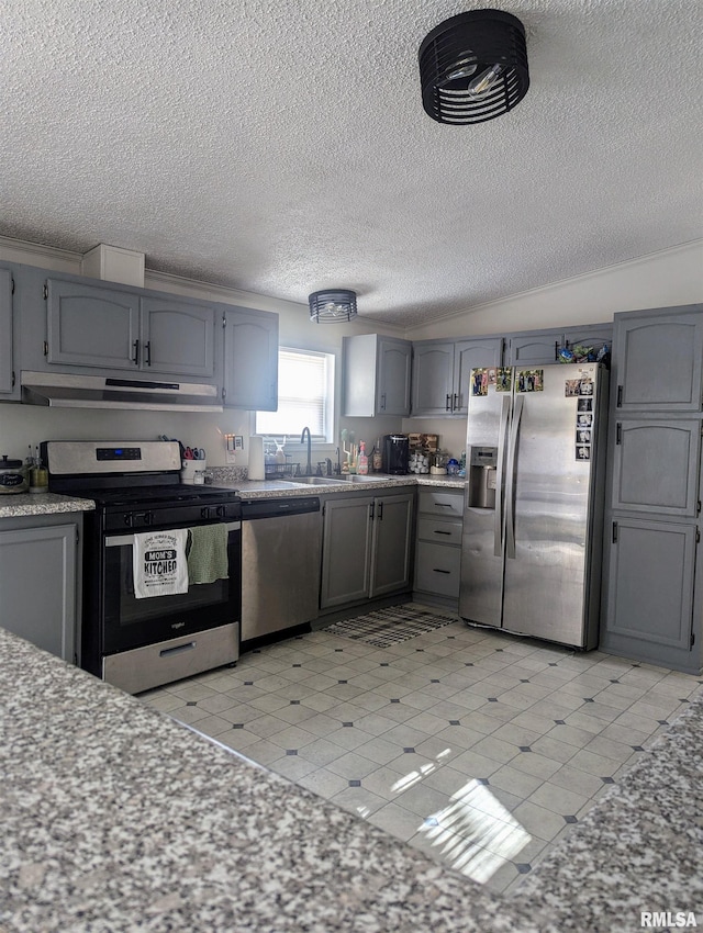 kitchen featuring sink, gray cabinets, a textured ceiling, and appliances with stainless steel finishes