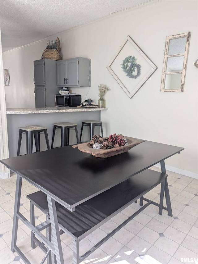 dining area featuring a textured ceiling