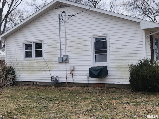 view of side of home with a lawn