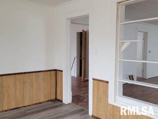 spare room with ornamental molding and dark hardwood / wood-style floors