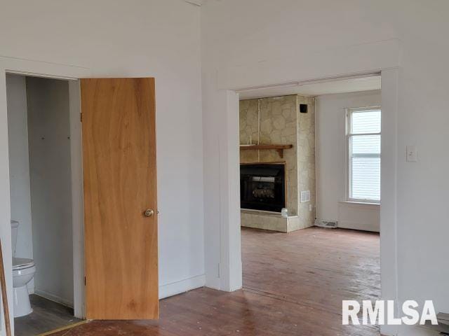 corridor with hardwood / wood-style flooring