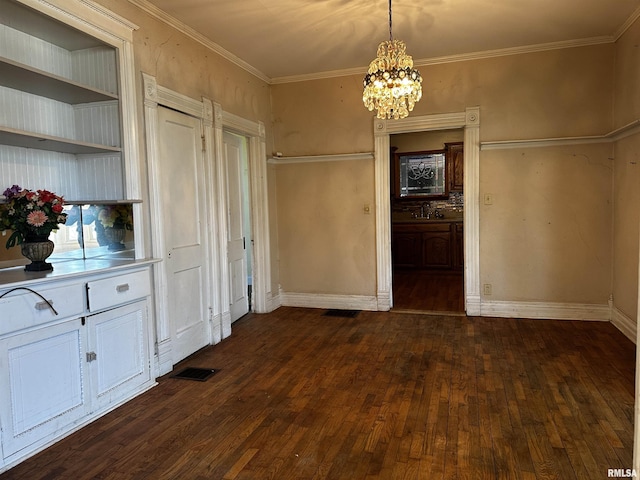 unfurnished dining area with a notable chandelier, crown molding, dark wood-type flooring, and sink