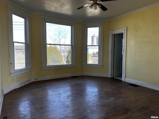 spare room with ornamental molding, dark hardwood / wood-style floors, and ceiling fan