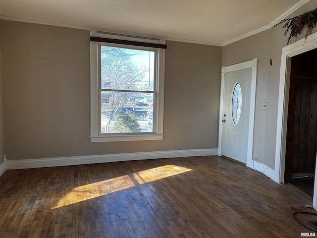 foyer with ornamental molding and dark hardwood / wood-style floors