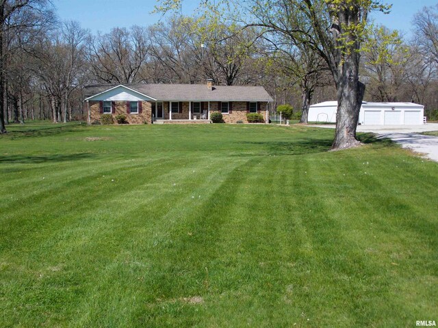 1723 Walnut Hill Rd, Centralia, IL 62801 - ranch-style house featuring a garage, a chimney, an outdoor structure, a front lawn, and a porch